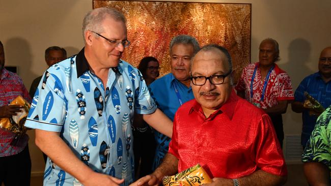 Australia's Prime Minister Scott Morrison gives Papua New Guinea Prime Minister Peter O'Neill a Wallabies rugby union jersey at a barbeque for Pacific Islands leaders at the Australian High Commission after the 2018 Asia-Pacific Economic Cooperation (APEC) forum in Port Moresby, Papua New Guinea, Sunday, November 18, 2018. (AAP Image/Mick Tsikas) NO ARCHIVING