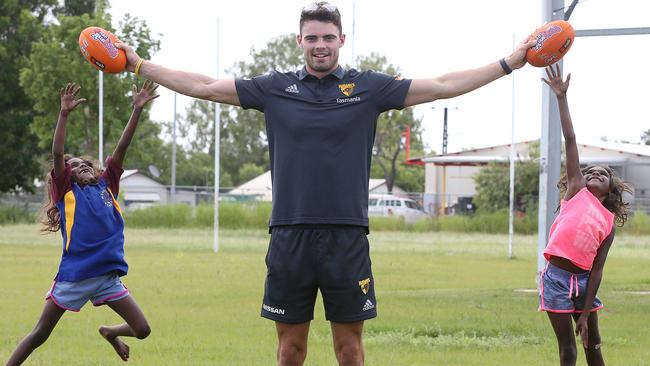 Conor Nash was a hit with six-year-old twins Hope and Faith at Wugulaar School at Beswick in the Northern Territory. Picture: Michael Klein