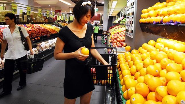 Fancy your oranges costing 13 per cent more ... Ashleigh Dang, 22, shops in the Fruitezy store in Chatswood, Sydney.