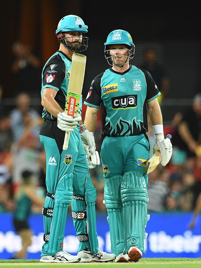 Ben Cutting of the Heat raises his bat after reaching a half century during the Big Bash League (BBL) match between the Brisbane Heat and the Hobart Hurricanes at Metricon Stadium on the Gold Coast. Picture: AAP IMAGE/DAVE HUNT