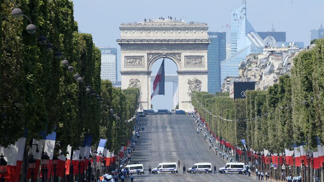 French police vehicles park park on the empty Champs-Elysees avenue after the annual Bastille Day military parade. Photo: AFP