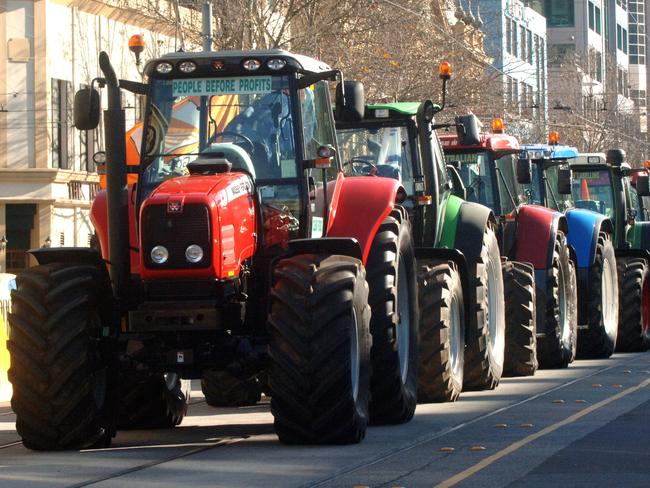 The Tasmanian tractors line up outside Parliament House in Spring Street.