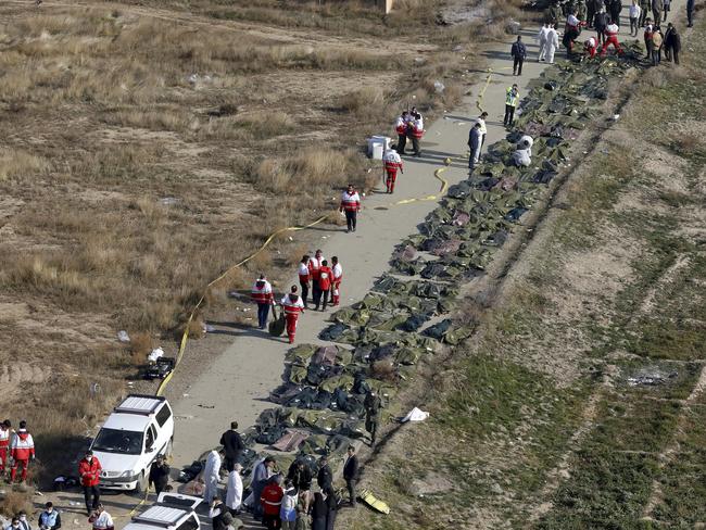 Bodies of the victims of a Ukrainian plane crash are collected by rescue team at the scene of the crash in Shahedshahr, southwest of the capital Tehran, Iran. Picture: AP