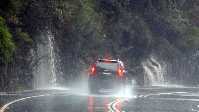 Waterfalls cascade on to the Wakehurst Parkway at Oxford Falls during heavy rain. Picture: John Grainger.