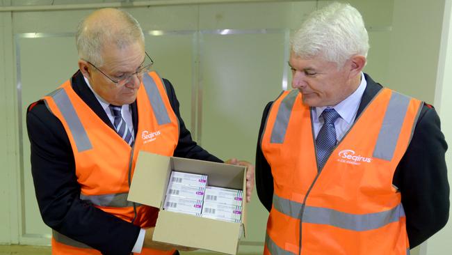 Scott Morrison and CSL chair Brian McNamee pictured last year with a box of AstraZeneca vaccine that CSL produced in Melbourne. Picture: NCA NewsWire/Andrew Henshaw