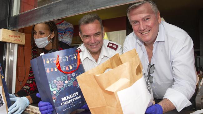 The Salvation Army’s Major Brendan Nottle with McGuire helping the Melbourne poor and homeless at Christmas. Picture: Sarah Matray