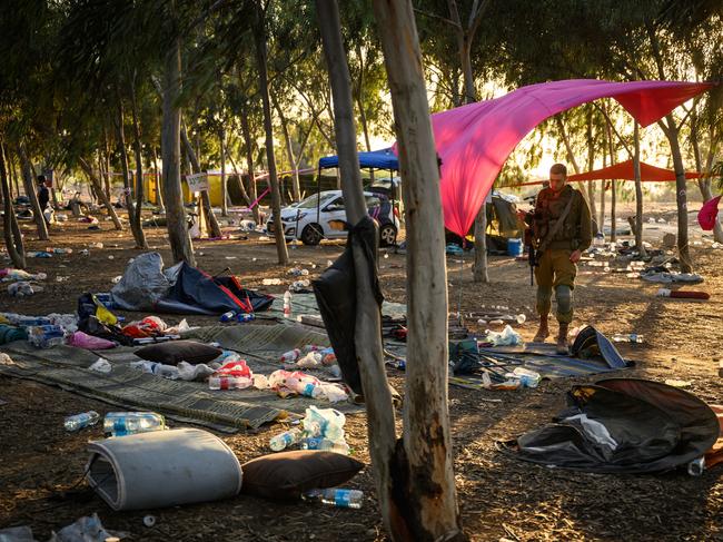 Members of the Israeli security forces search for identification and personal effects at the Supernova music festival site. Picture: Getty