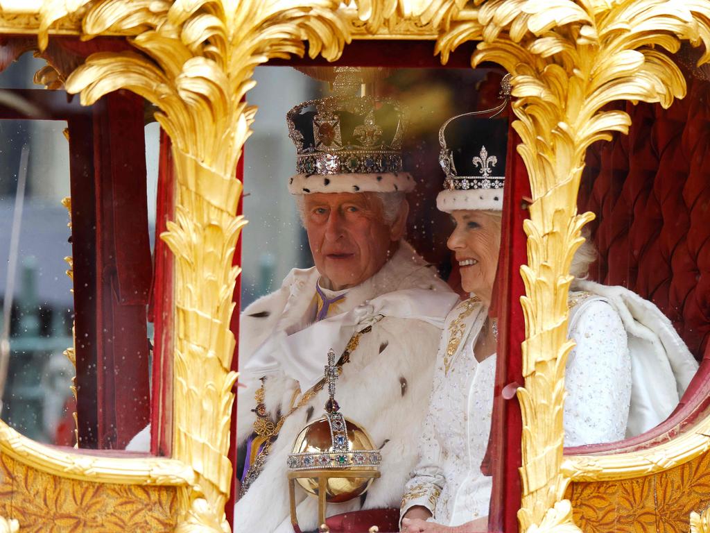 King Charles III and Queen Camilla share a private moment in the Gold State Coach after being crowned. Picture: AFP