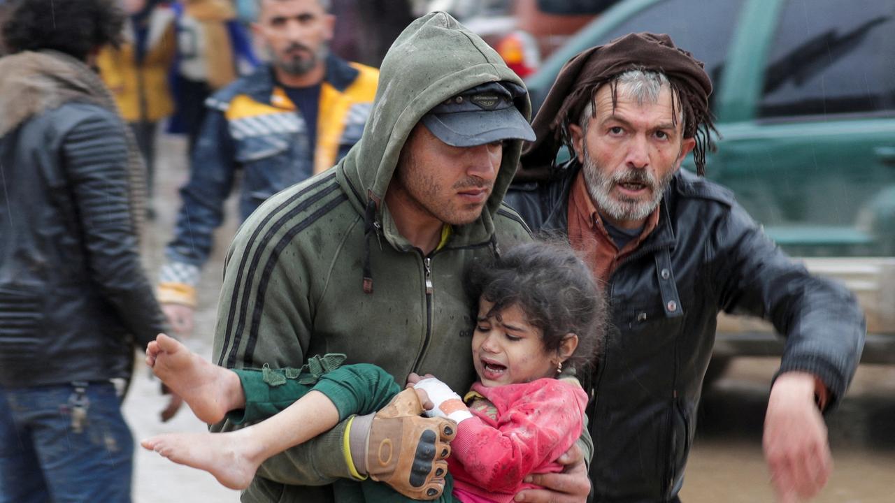 A man carries a girl after an earthquake in the rebel city of Jandaris, Syria. 6th February 2023. REUTERS/Khalil Ashawi