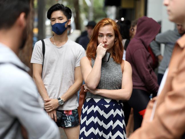 Newly unemployed retail assistant Celeste Mather, 21, fights back tears as she waits in line at a Centrelink office in Sydney. Picture: Jane Dempster