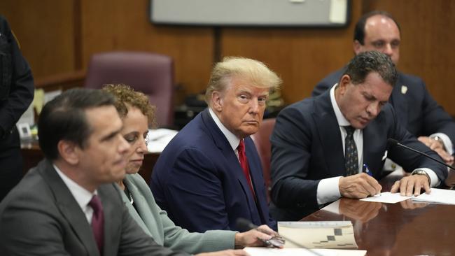 Former US President Donald Trump with his defence team during his arraignment at court in New York on April 4.