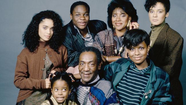 Bill Cosby with the fictional Huxtable family from the TV show The Cosby Show.