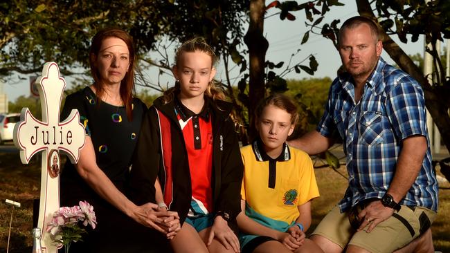 Michelle Graham with husband Nathan, and Holly and Abbey at the memorial for her mother Julie who was killed in a car accident near the intersection of Weston Street and Woolcock Street. Picture: Evan Morgan