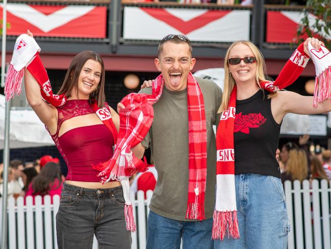 Anneliese Scholten, Hayley Brent and James Forster supporting the Sydney Swans. Picture Thomas Lisson