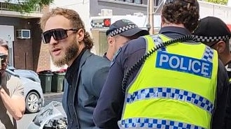 Joel Davis arrested by SAPOL officers for displaying nazi symbol at rally yesterday. Picture: The Advertiser