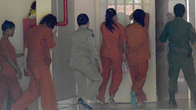 Tammy Davis-Charles, second left, with other detainees at Phnom Penh municipal court. Picture: Tang Chhin Sothy.