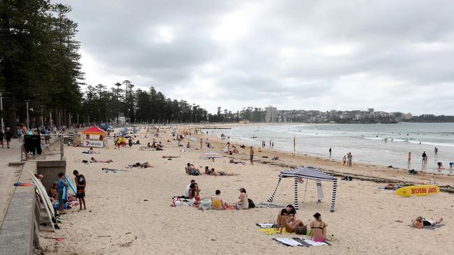 People on Manly beach on Saturday, March 21 keep a safe distance from each other. Picture: Damian Shaw