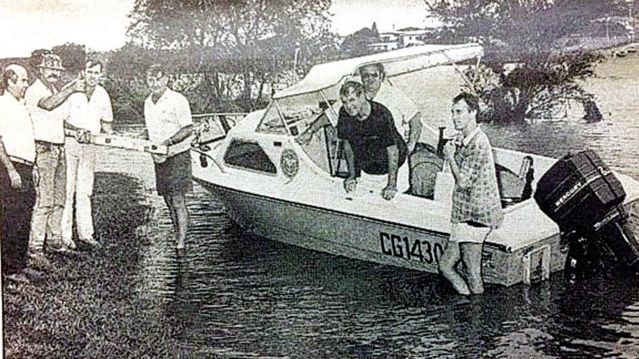 With the shift of the printing press to the Gympie Industrial Estate, floods presented a few problems in getting the pages to the press. In 1989 they went by boat. Handing over the pages at Deep Creek near Inglewood Bridge were (from left) Dave Bower, Ivan McNicholl, Michael Roser, Wayne Gosley, Jim Saunders, Rod Bateman and Ray Zeric.