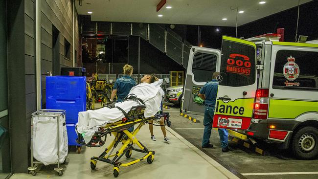 The crew bring a young man into Gold Coast University Hospital after he suffered a seizure. Picture: Jerad Williams