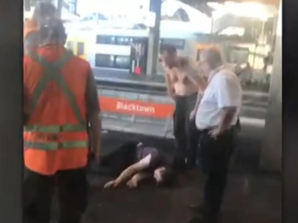 The shirtless guard flicked the man off his leg. Picture: Channel 7