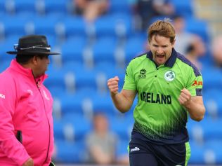 Ireland's Barry McCarthy (R) celebrates his wicket of West Indies' Kyle Mayers.