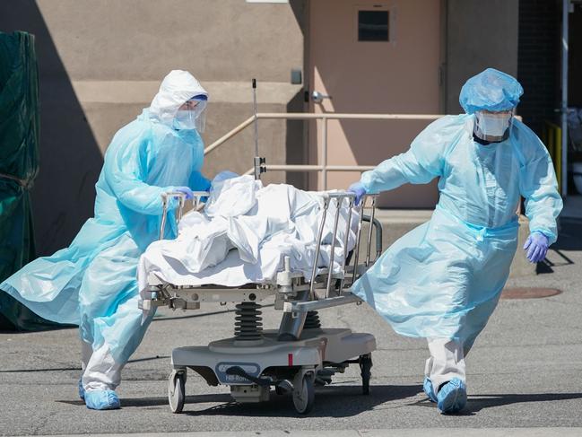 Bodies are moved to a refrigeration truck in New York in April 2020. Picture: AFP