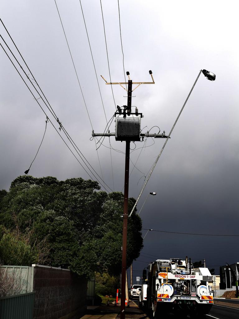 Dark skies outline damaged power lines on Commercial Rd at Port Noarlunga. Picture: Campbell Brodie