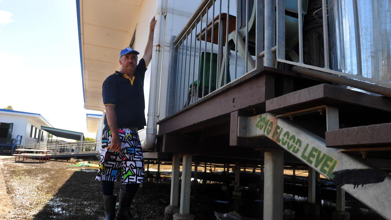 SCHOOL'S PAIN: Bundaberg East State School principal Doug Ambrose indicates the height the 2013 flood compared to the 2010 flood level. Photo: Max Fleet / NewsMail