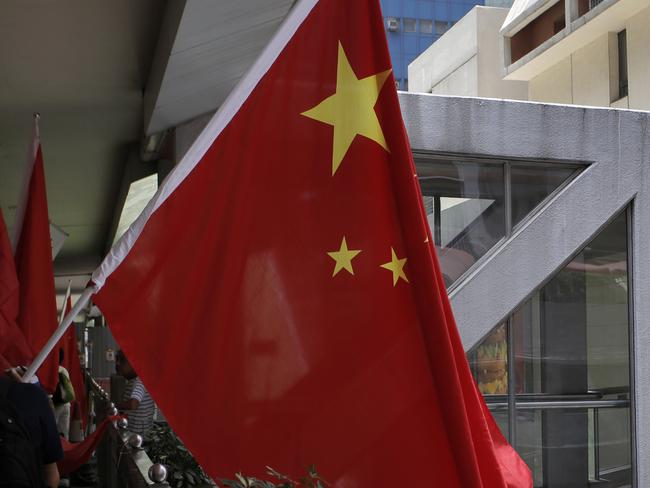 Pro-China supporters march with Chinese national flags during a rally to mark the 18th anniversary of Hong Kong's handover to China in Hong Kong, Wednesday, July 1, 2015. (AP Photo/Vincent Yu)