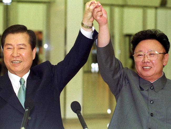 Kim Dae-jung and Kim Jong-il raise their arms together before signing a joint declaration at the end of the second day of a three-day summit in Pyongyang. Picture: Yonhap/AP