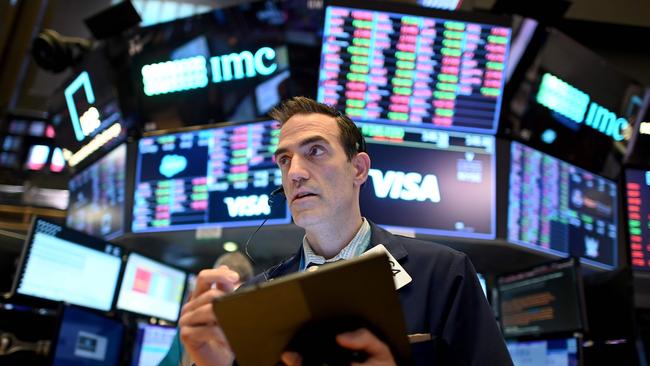 Morgan Stanley has warned cash will beat US shares over the next 12 months. Above, traders work during the closing bell at the New York Stock Exchange pre-pandemic. Picture: AFP