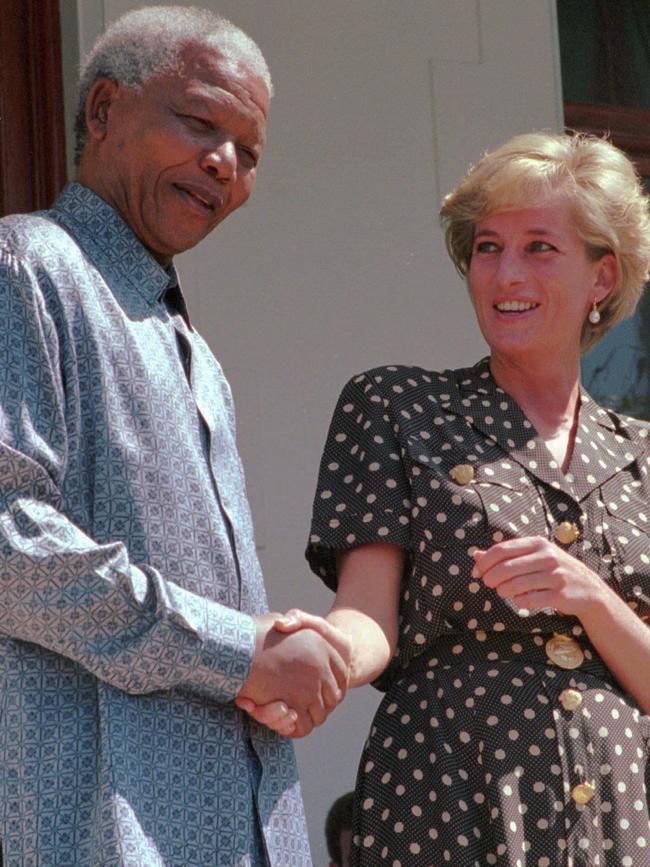 South African President Nelson Mandela, left, holds hands with Diana Princess of Wales in 1997. Picture: AP.