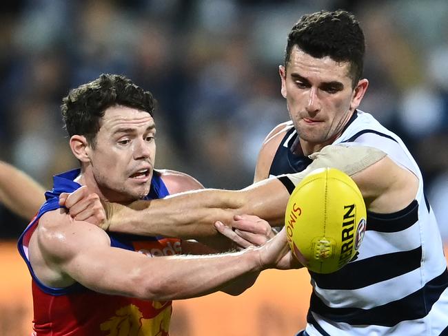 GEELONG, AUSTRALIA - MARCH 26: Lachie Neale of the Lions and Mark O'Connor of the Cats compete for the ball during the round 2 AFL match between the Geelong Cats and the Brisbane Lions at GMHBA Stadium on March 26, 2021 in Geelong, Australia. (Photo by Quinn Rooney/Getty Images)