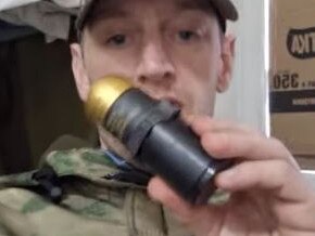 Ben Stimson, with a grenade, taunted Brits by saying he was holding “British taxpayer returns”. Picture: Supplied