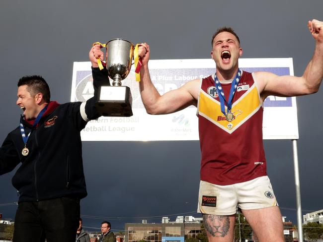 Lower Plenty coach Ben Turner and captain Patrick Flynn celebrate the club’s Division 2 grand final victory. 