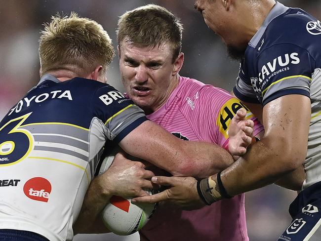 TOWNSVILLE, AUSTRALIA - MAY 10: Luke Garner of the Panthers is tackled during the round 10 NRL match between North Queensland Cowboys and Penrith Panthers at Queensland Country Bank Stadium, on May 10, 2025, in Townsville, Australia. (Photo by Ian Hitchcock/Getty Images)