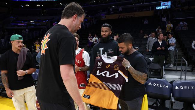 Adam Reynolds presents Spurs assistant coach Matthew Nielsen of the San Antonio Spurs with a jersey.