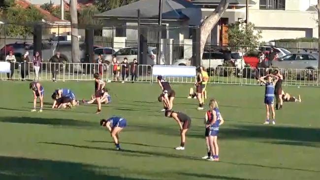 Exhausted Sacred Heart and Rostrevor players collapse in disbelief after their Intercol draw. Picture: Fiming Footy