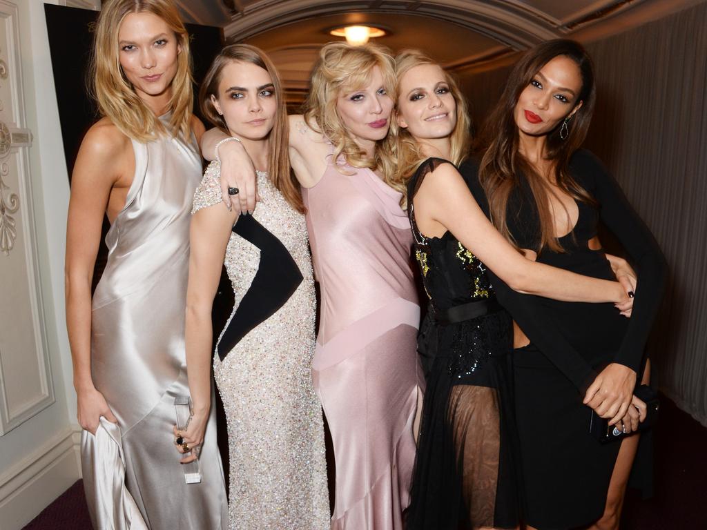 (L to R) Karlie Kloss, Model of the Year winner Cara Delevingne, Courtney Love, Poppy Delevingne and Joan Smalls attend the British Fashion Awards at the London Coliseum on December 1, 2014 in London, England. Picture: Getty