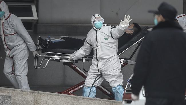 Medical staff transfer patients to Jin Yintan Hospital on Monday in Wuhan, Hubei, China. Picture: Getty