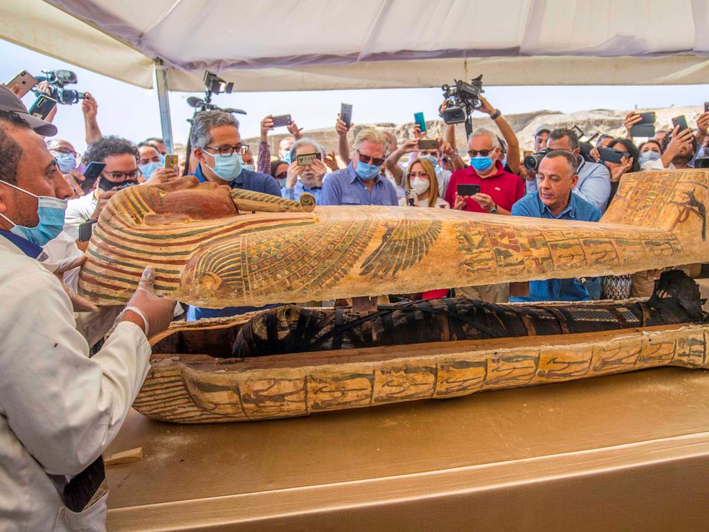 Egyptian Minister of Tourism and Antiquities Khaled Al-Enany opens a sarcophagus excavated at the Saqqara necropolis. Picture: Khaled Desouki/AFP