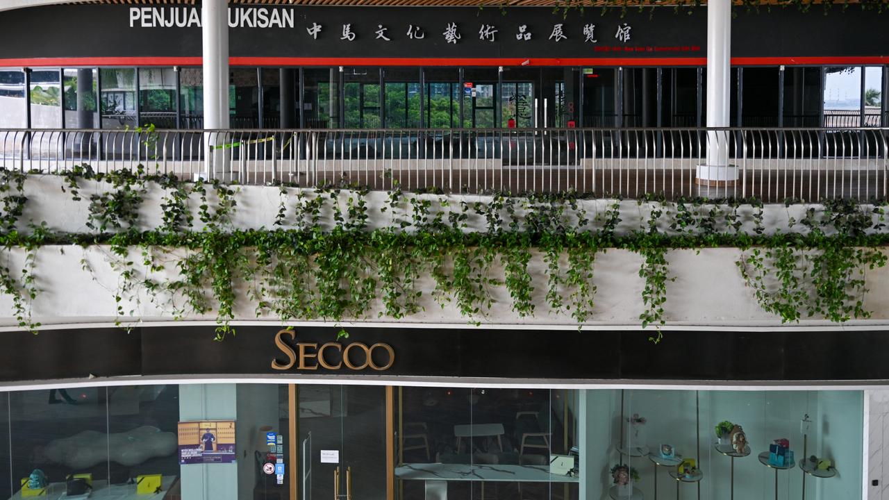 Closed shops are seen inside the Forest City Outlet Mall. Picture: Mohd RASFAN / AFP.