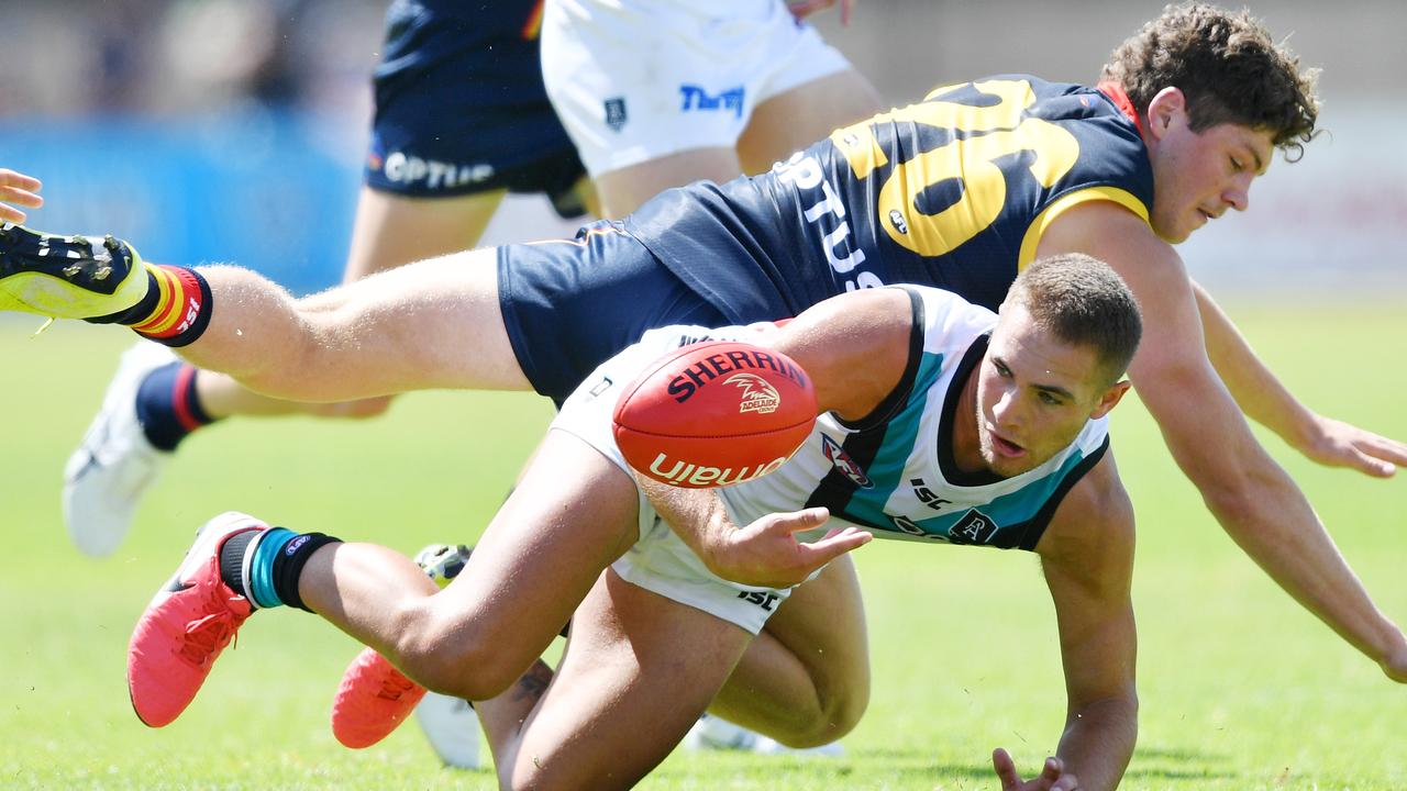 Harry Schoenberg of the Crows and Boyd Woodcock of the Power contest the ball during the practice match at Thebarton Oval. Picture: David Mariuz/AAP