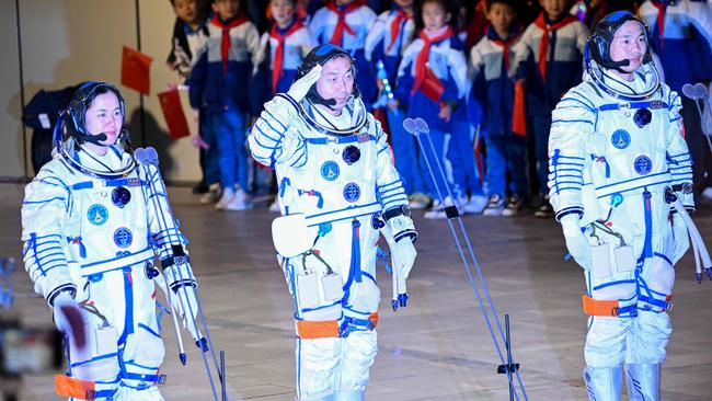 Astronaut Cai Xuzhe (C) salutes, as he stands next to Song Lingdong (R) and Wang Haoze (L) during a departure ceremony ahead of the space launch. Picture: AFP.