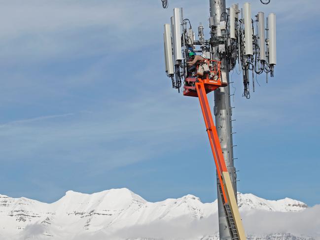 A specialist crew working on a cell tower to update to update it for the new 5G network. Picture: George Frey/AFP