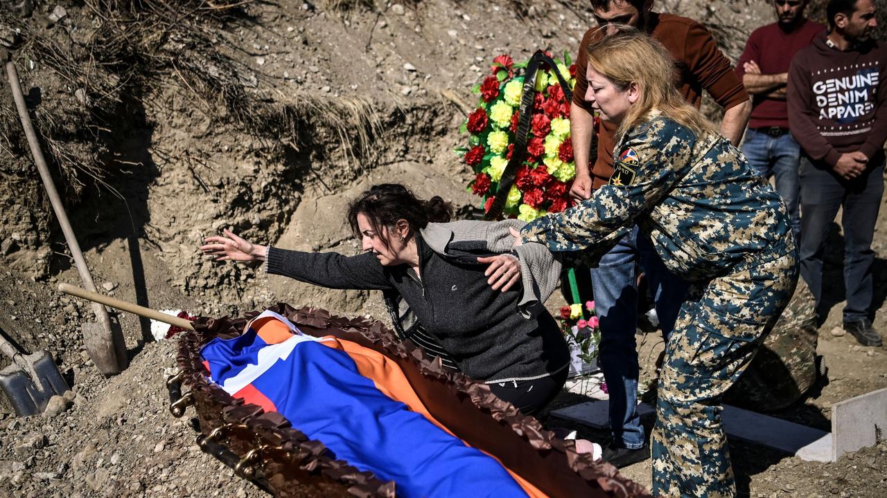 A mother mourns over the coffin of her son. Azerbaijan's President Ilham Aliyev vowed on October 17 to take revenge on Armenia after a missile strike killed 12 sleeping people in the city of Ganja, a dramatic escalation in the conflict over the disputed Nagorno-Karabakh region. Picture: ARIS MESSINIS / AFP.