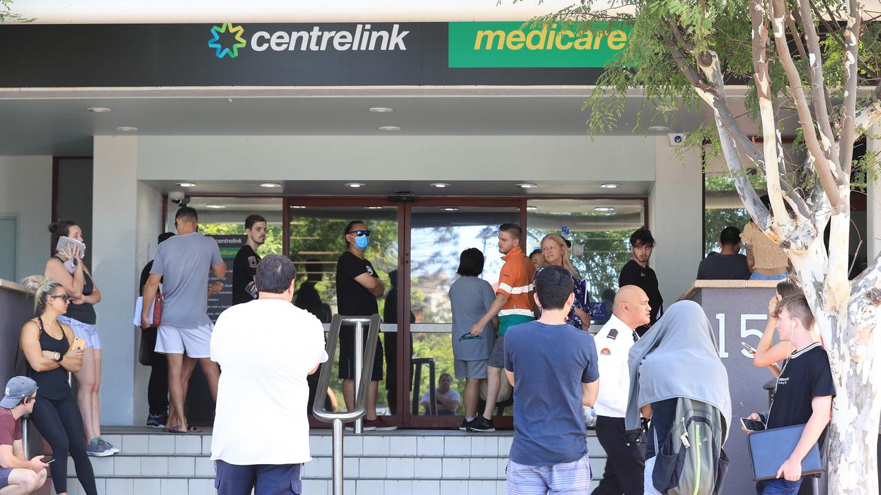 Lines of people wait at Southport Centrelink. Picture: Adam Head.