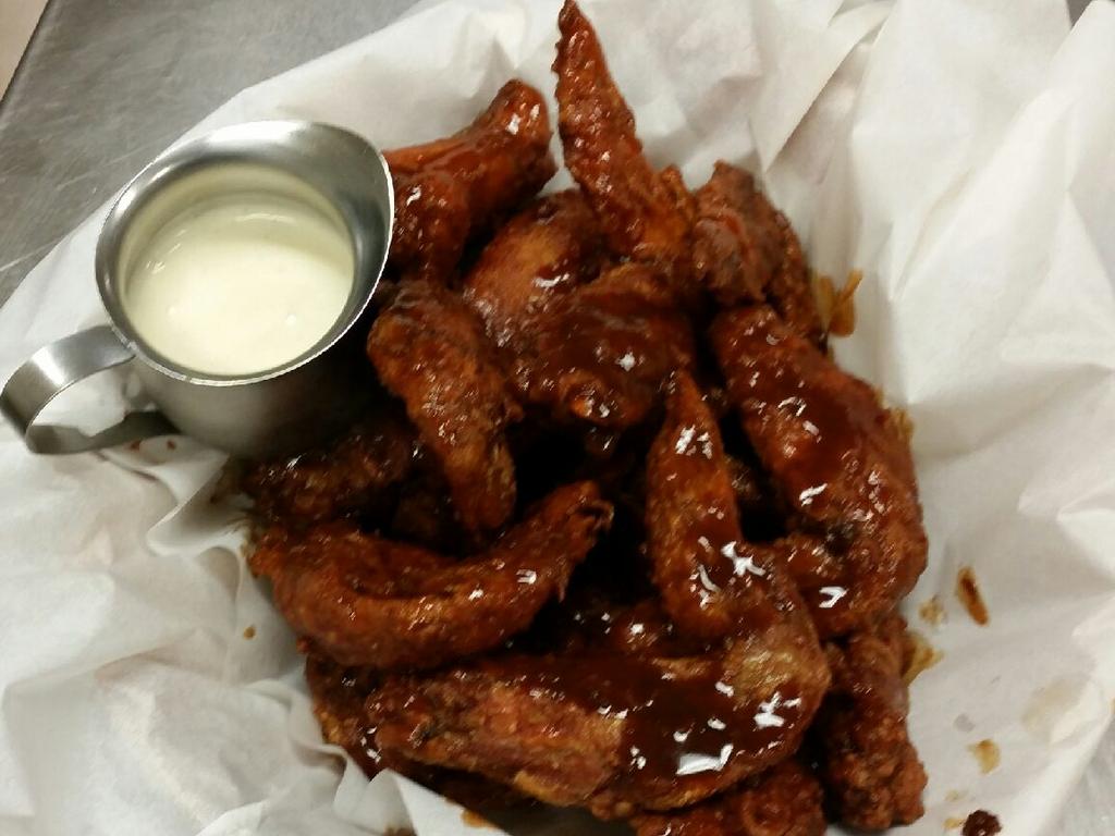 <span class="h2">Carolina Kitchen</span>                  <b>2/38 Macaulay St, Coorparoo. Price: Six wings for $7.95.</b> Carolina is one of the few places that serve their wings with the tips intact, making them bigger than most places. These were super crispy with gnarly bits, and most of the sauce pooling on the bottom. The wings were a little dry, but the bevy of sauces on offer – we mixed the blue cheese with the ghost chilli – made them more palatable. We also liked that the blue cheese was served in a huge bottle, rather than in a tiny side dish. <b><a href="https://www.facebook.com/pages/Carolina-Kitchen/183652371654871" title="www.facebook.com">More details</a></b>