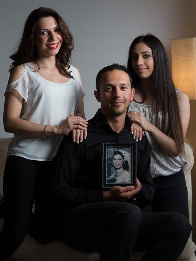 Atena, Arman and Anita Abrahimzadeh with a photograph of their late mother Zahra.