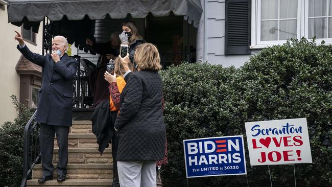 Joe Biden waves to onlookers from the steps of his childhood home in Scranton, Pennsylvania. Picture: AFP.